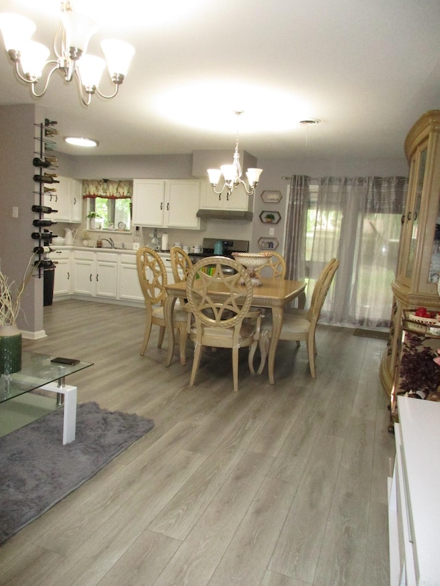 4005 Arapaho Trl, Little Rock, AR 72209 - dining space with a chandelier and light wood-style flooring
