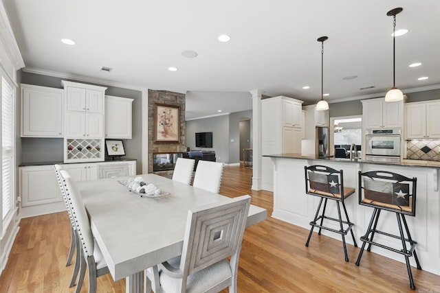 15 Challain Cv, Little Rock, AR 72223 - dining space featuring ornamental molding, recessed lighting, and light wood-style flooring