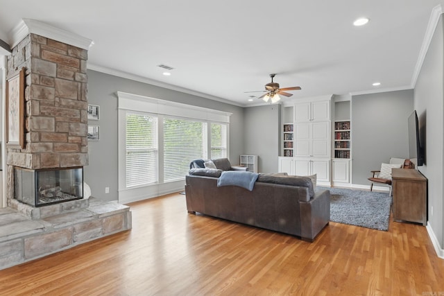 15 Challain Cv, Little Rock, AR 72223 - living room featuring light wood finished floors, ceiling fan, crown molding, a fireplace, and recessed lighting