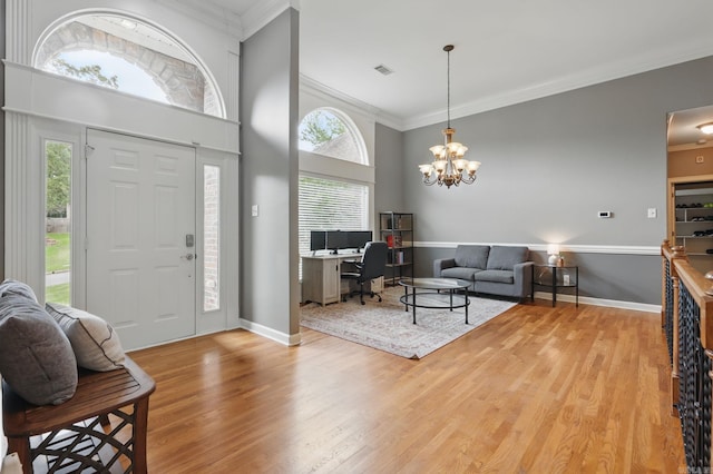 15 Challain Cv, Little Rock, AR 72223 - entrance foyer with crown molding, wood finished floors, healthy amount of natural light, a chandelier, and a towering ceiling