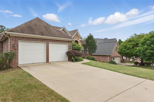 15 Challain Cv, Little Rock, AR 72223 - view of front of property featuring brick siding, roof with shingles, a front lawn, a garage, and concrete driveway