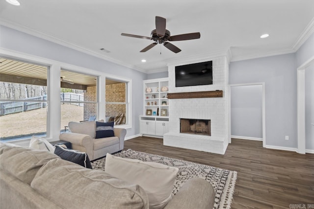 7841 S Shoreline Blvd, Benton, AR 72019 - living area with a ceiling fan, a brick fireplace, baseboards, dark wood finished floors, and ornamental molding