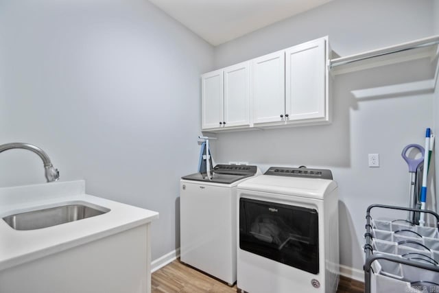7841 S Shoreline Blvd, Benton, AR 72019 - washroom featuring cabinet space, separate washer and dryer, light wood-style floors, and baseboards