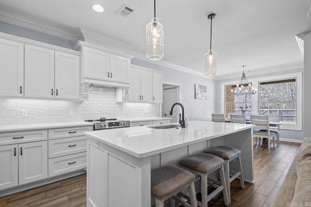 7841 S Shoreline Blvd, Benton, AR 72019 - kitchen with a sink, white cabinetry, light countertops, an island with sink, and ornamental molding