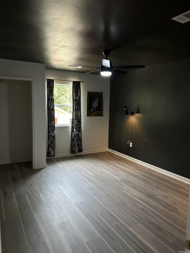 18 Riviera Dr, Conway, AR 72034 - spare room featuring a ceiling fan, wood finished floors, and baseboards
