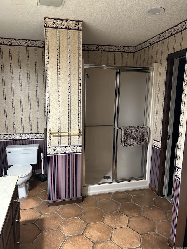 18 Riviera Dr, Conway, AR 72034 - bathroom featuring wallpapered walls, a stall shower, vanity, toilet, and a textured ceiling