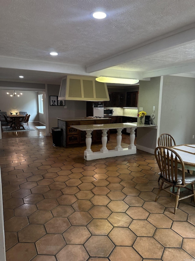 18 Riviera Dr, Conway, AR 72034 - kitchen with a textured ceiling, recessed lighting, a peninsula, stainless steel microwave, and a breakfast bar