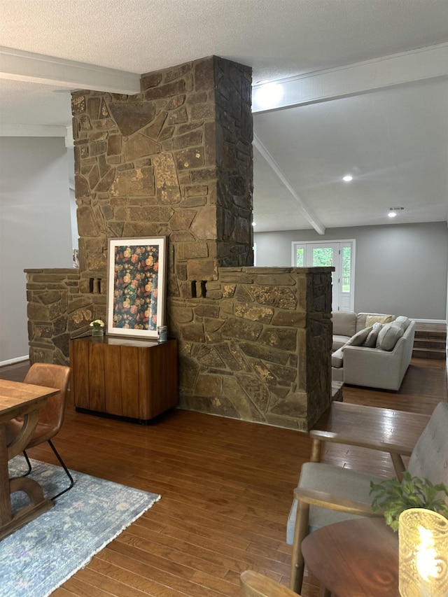 18 Riviera Dr, Conway, AR 72034 - living area featuring beamed ceiling, hardwood / wood-style flooring, and a stone fireplace