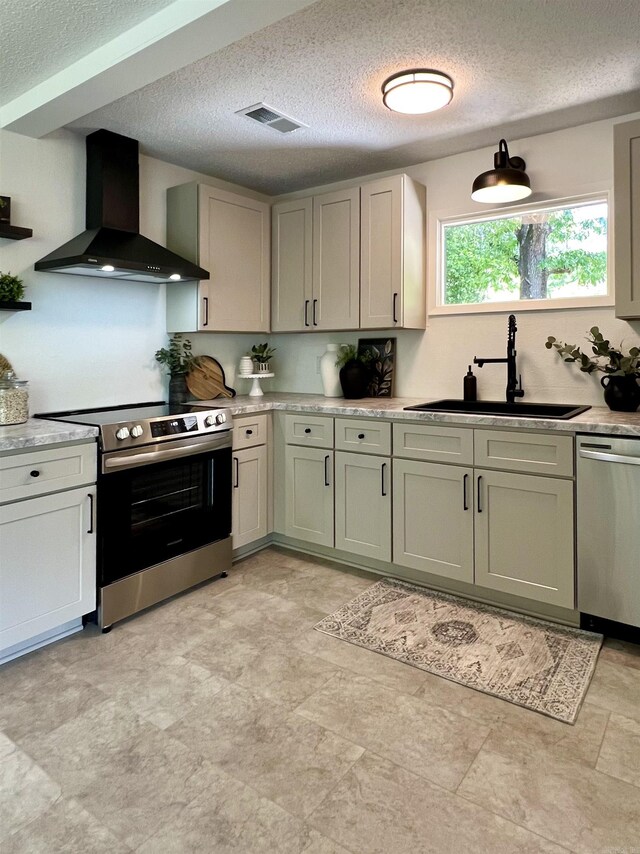 506 W Clinton St, Heber Springs, AR 72543 - kitchen featuring wall chimney exhaust hood, stainless steel appliances, a sink, light countertops, and a textured ceiling