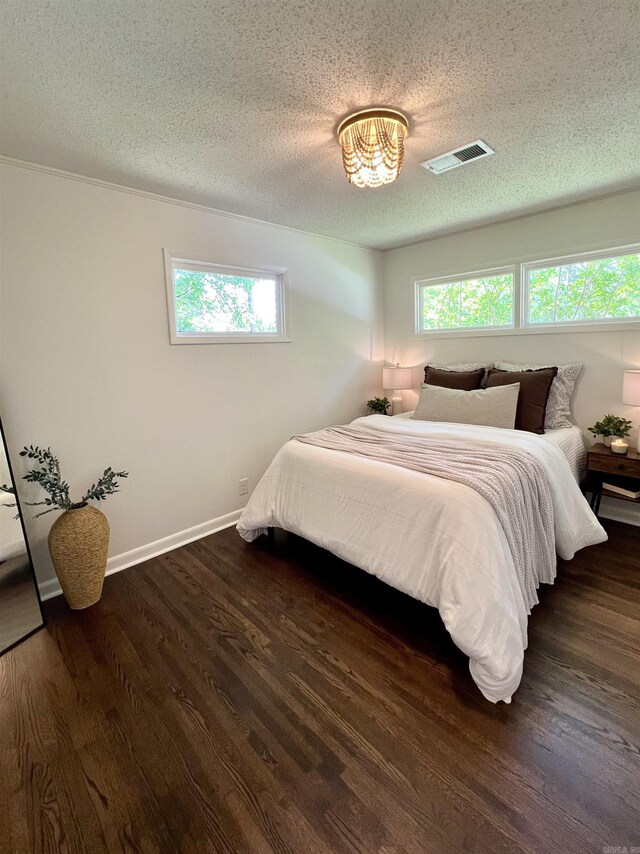 506 W Clinton St, Heber Springs, AR 72543 - bedroom with dark wood-type flooring, a textured ceiling, and baseboards