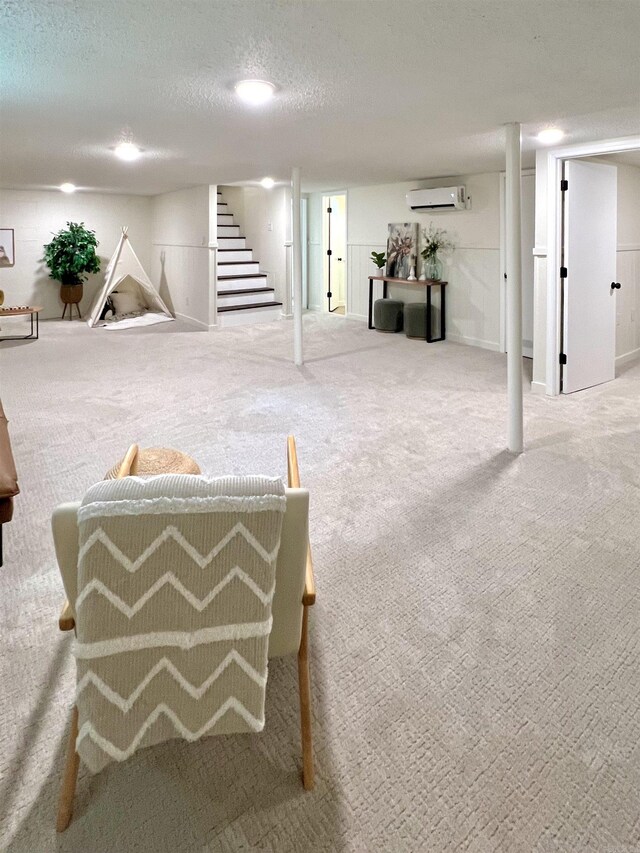 506 W Clinton St, Heber Springs, AR 72543 - finished below grade area with stairs, a wall unit AC, carpet floors, and a textured ceiling
