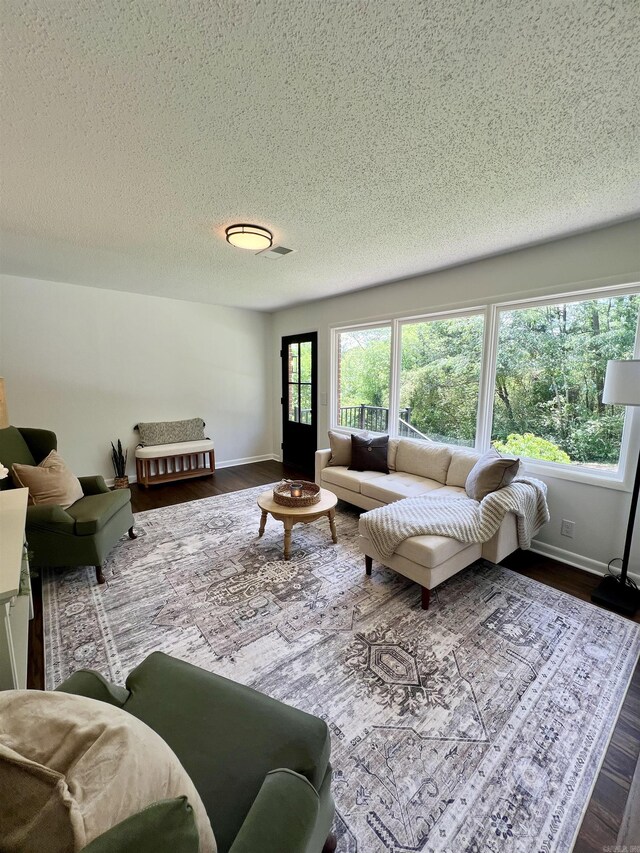 506 W Clinton St, Heber Springs, AR 72543 - living area with a textured ceiling, dark wood finished floors, and baseboards