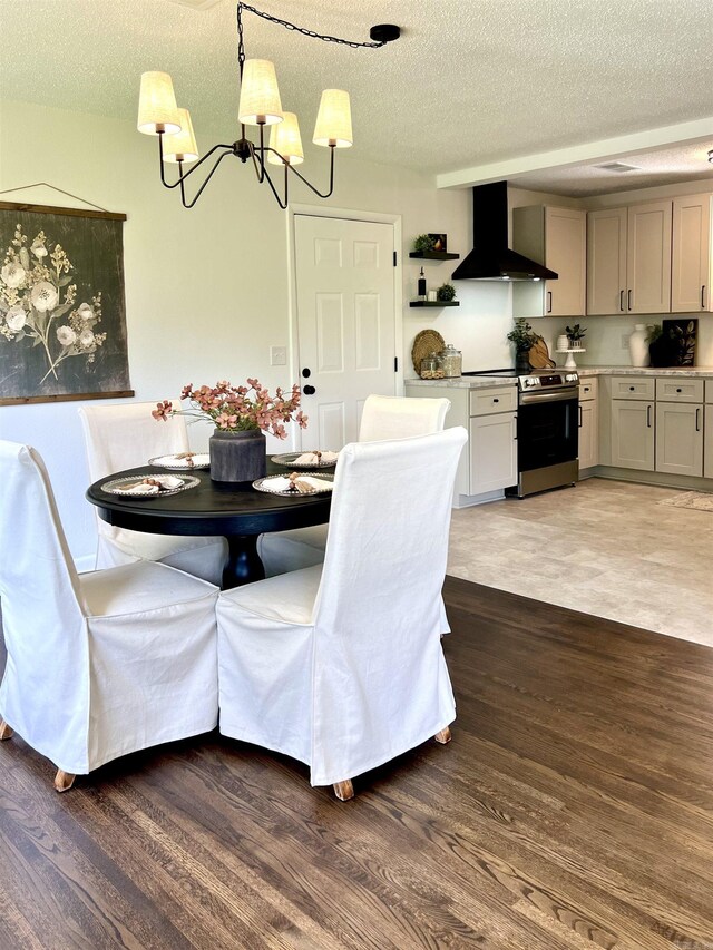506 W Clinton St, Heber Springs, AR 72543 - dining space with a chandelier, wood finished floors, and a textured ceiling
