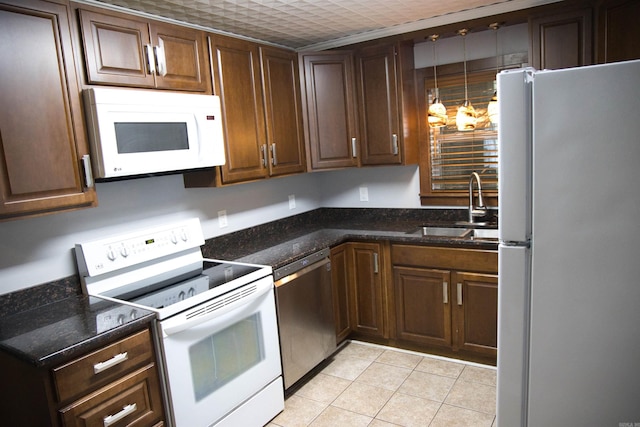 510 Frances, Magnolia, AR 71753 - kitchen with white appliances, a sink, light tile patterned flooring, and dark stone counters
