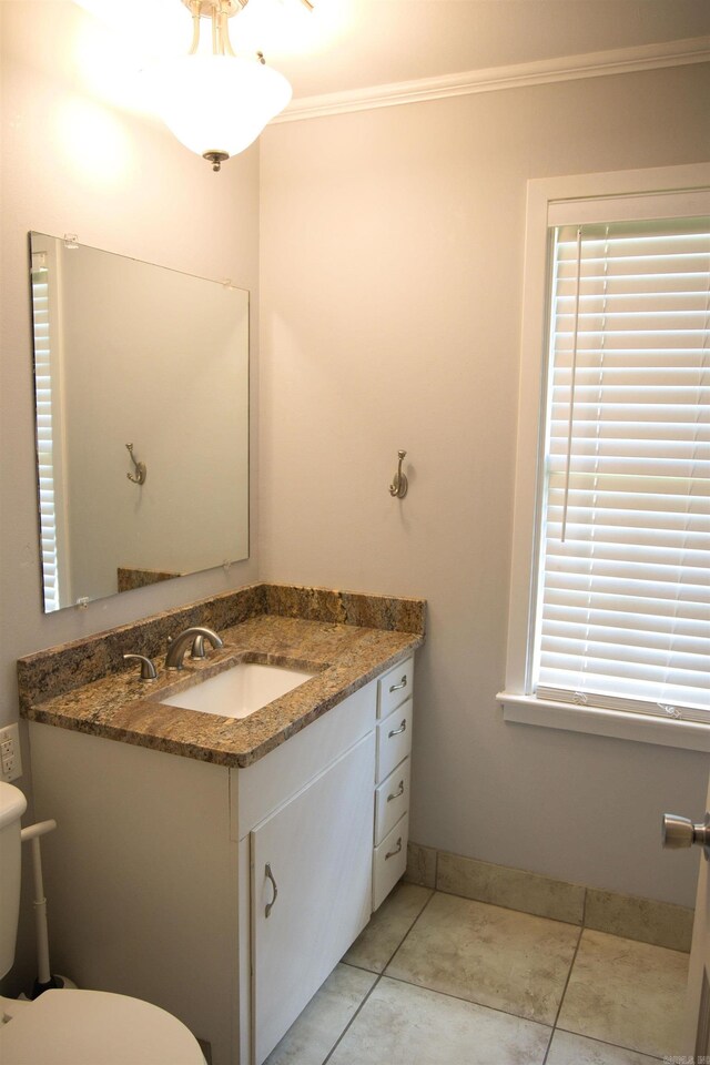 510 Frances, Magnolia, AR 71753 - half bathroom featuring crown molding, vanity, toilet, baseboards, and tile patterned flooring
