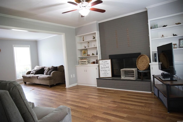 510 Frances, Magnolia, AR 71753 - living room featuring a fireplace, ceiling fan, ornamental molding, built in features, and wood finished floors