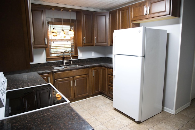 510 Frances, Magnolia, AR 71753 - kitchen with freestanding refrigerator, a sink, light tile patterned floors, and stove