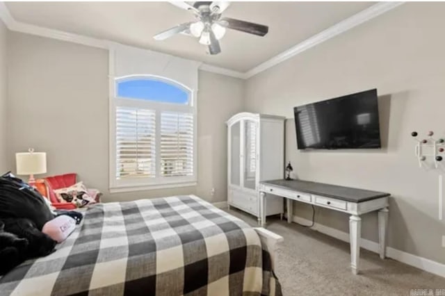 carpeted bedroom featuring crown molding, baseboards, and a ceiling fan