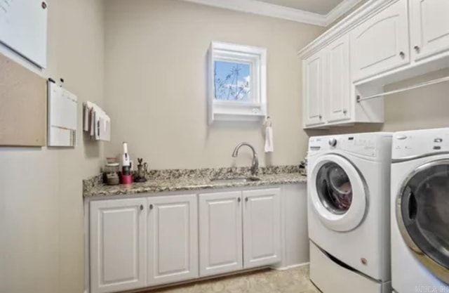 laundry area with cabinet space, independent washer and dryer, and crown molding