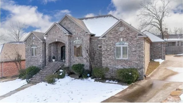 traditional home featuring stone siding