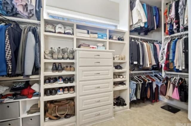 spacious closet with tile patterned floors