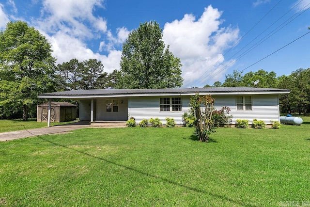 135 Cress Ln, Clinton, AR 72031 - ranch-style home with a storage unit, an outdoor structure, concrete driveway, a carport, and a front lawn