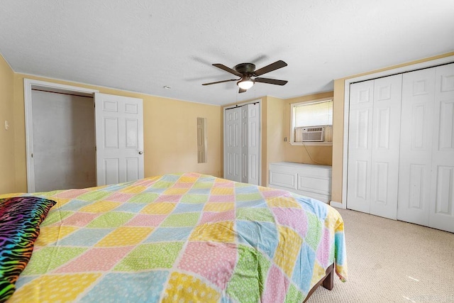 135 Cress Ln, Clinton, AR 72031 - bedroom featuring two closets, ceiling fan, cooling unit, a textured ceiling, and carpet floors