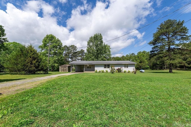135 Cress Ln, Clinton, AR 72031 - ranch-style house featuring driveway, a shed, an attached carport, an outdoor structure, and a front yard