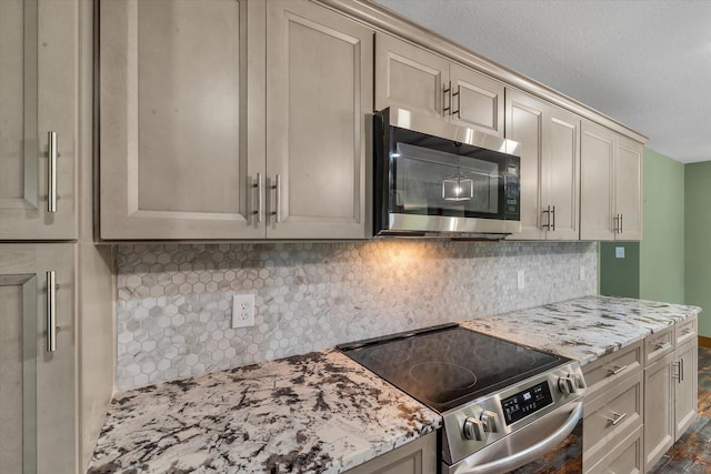 17259 Reynolds Rd, Harrisburg, AR 72432 - kitchen with stainless steel appliances, tasteful backsplash, light stone countertops, and cream cabinetry