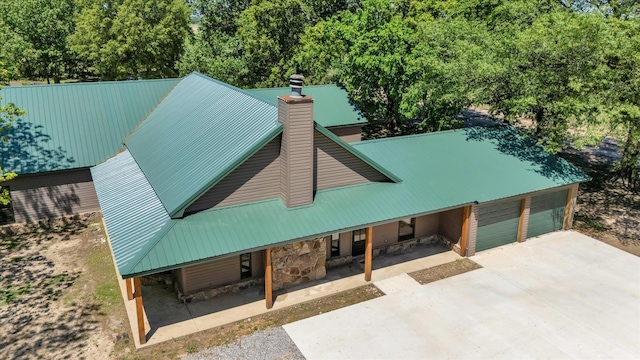 17259 Reynolds Rd, Harrisburg, AR 72432 - view of front facade with metal roof, a garage, concrete driveway, and stone siding