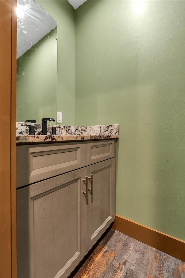 17259 Reynolds Rd, Harrisburg, AR 72432 - bathroom featuring wood finished floors, baseboards, and vanity