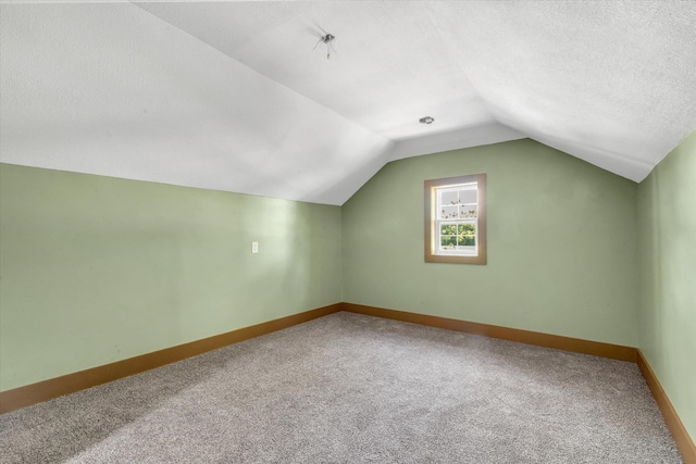 17259 Reynolds Rd, Harrisburg, AR 72432 - additional living space featuring carpet flooring, baseboards, lofted ceiling, and a textured ceiling