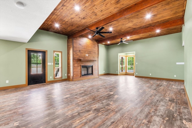 17259 Reynolds Rd, Harrisburg, AR 72432 - unfurnished living room with a ceiling fan, wood finished floors, a large fireplace, beam ceiling, and baseboards
