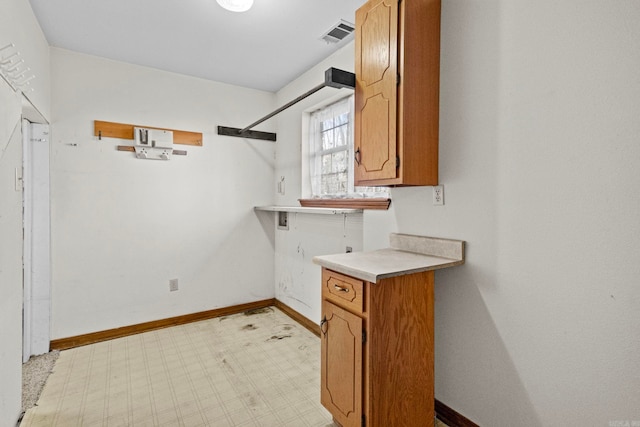 204 Pleasant Ridge Rd, El Paso, AR 72045 - washroom featuring cabinet space, baseboards, and light floors