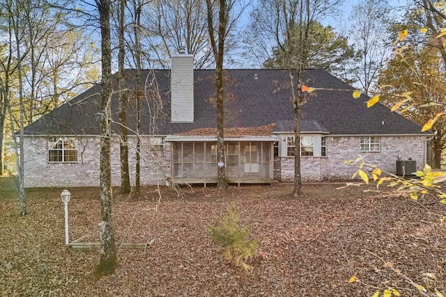 204 Pleasant Ridge Rd, El Paso, AR 72045 - rear view of house featuring a sunroom, central AC, brick siding, and a chimney