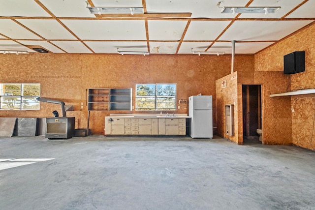 204 Pleasant Ridge Rd, El Paso, AR 72045 - misc room featuring healthy amount of natural light, unfinished concrete flooring, a sink, a high ceiling, and a garage