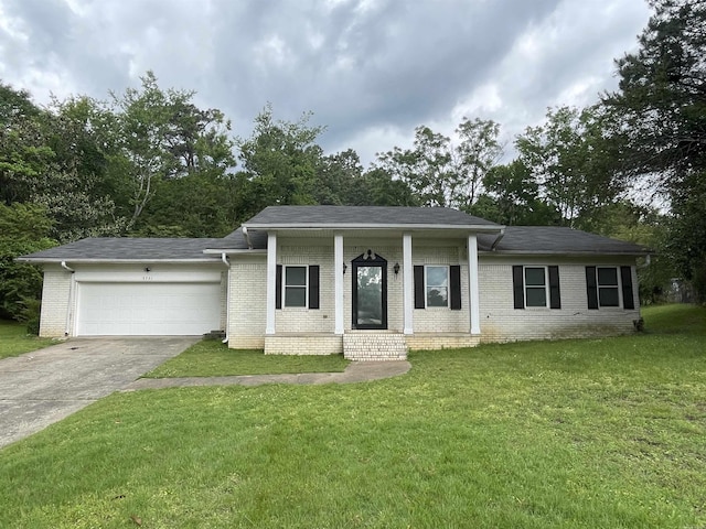 ranch-style house with a garage, brick siding, driveway, a front yard, and roof with shingles