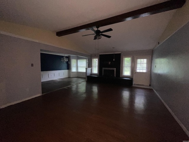unfurnished living room with a ceiling fan, healthy amount of natural light, wood finished floors, and a fireplace