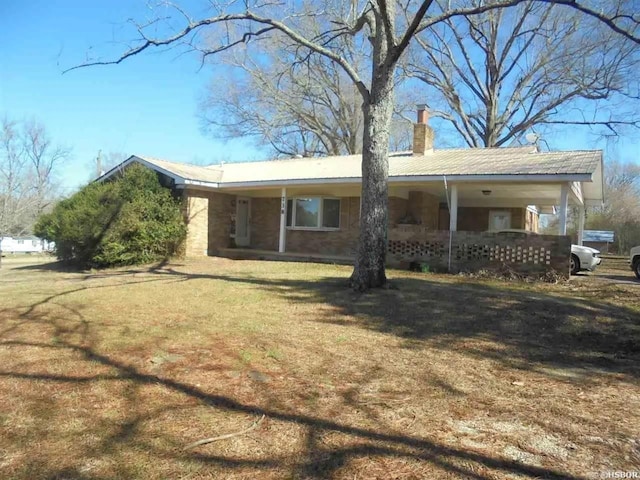 738 Pine, Amity, AR 71921 - back of property with a chimney, a lawn, covered porch, and metal roof