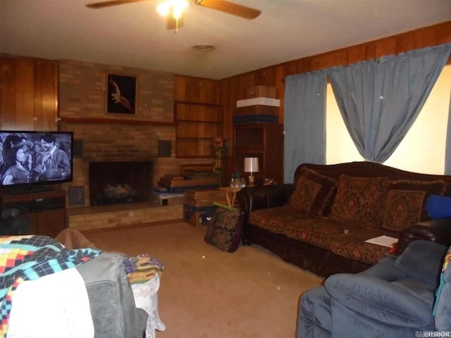 738 Pine, Amity, AR 71921 - living area featuring carpet, ceiling fan, a fireplace, and wood walls