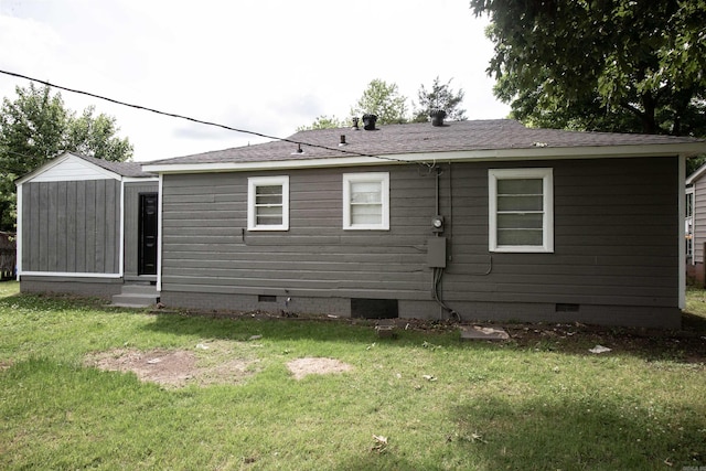back of property with crawl space, entry steps, and a yard