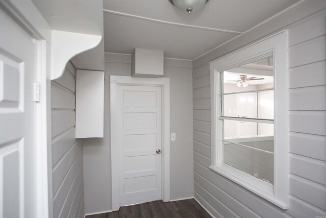 doorway featuring dark wood-type flooring and ceiling fan