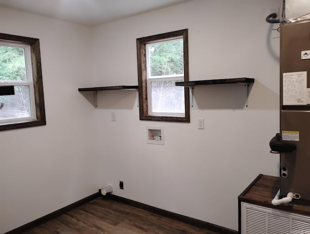 washroom with washer hookup, dark wood-style floors, hookup for an electric dryer, baseboards, and heating unit