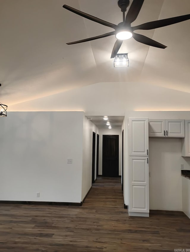 unfurnished room featuring a ceiling fan, dark wood-style floors, and vaulted ceiling