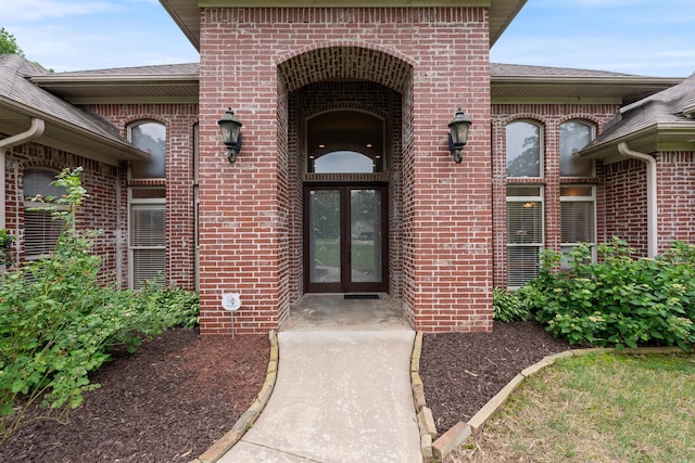 529 Enchanted Valley Ln, North Little Rock, AR 72118 - view of exterior entry with french doors, brick siding, and a shingled roof