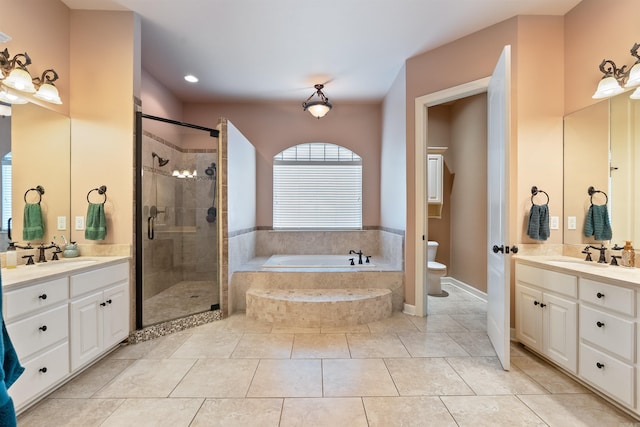 529 Enchanted Valley Ln, North Little Rock, AR 72118 - full bathroom with a stall shower, a garden tub, toilet, two vanities, and recessed lighting