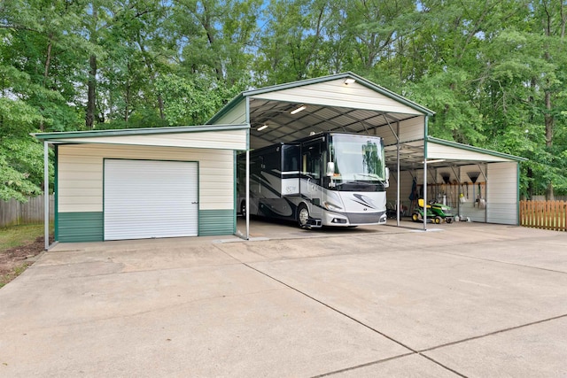 529 Enchanted Valley Ln, North Little Rock, AR 72118 - garage featuring fence, driveway, and a detached garage