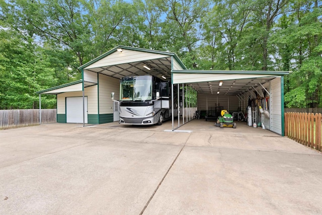 529 Enchanted Valley Ln, North Little Rock, AR 72118 - view of parking / parking lot featuring fence and a detached garage