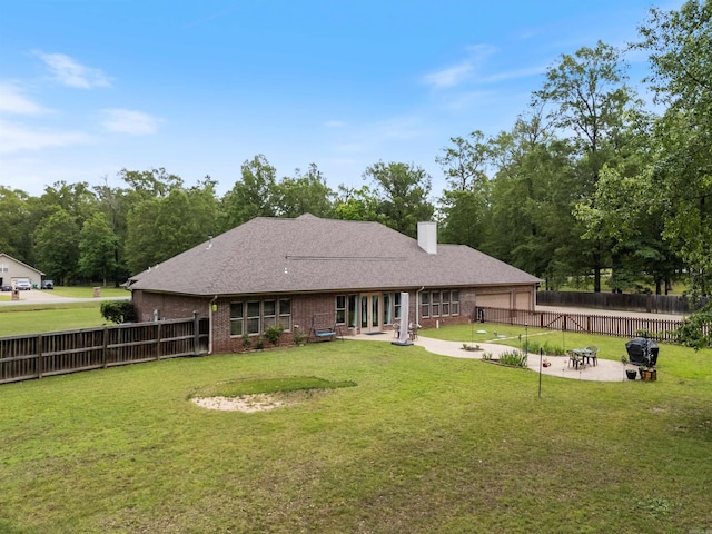 529 Enchanted Valley Ln, North Little Rock, AR 72118 - rear view of house with a patio, brick siding, a chimney, and a garage