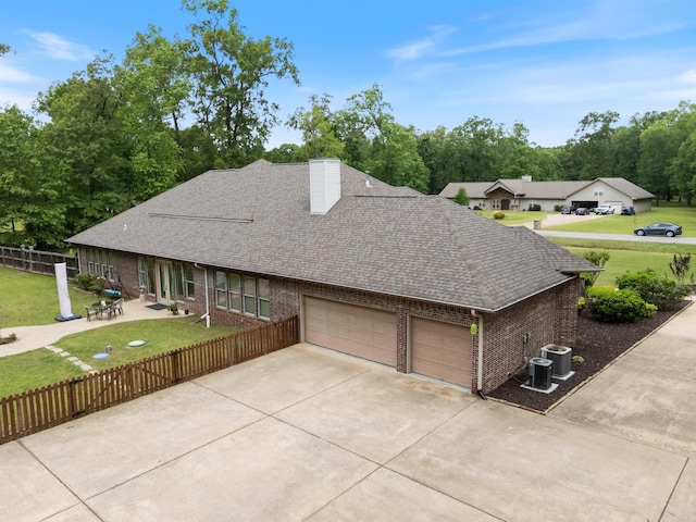 529 Enchanted Valley Ln, North Little Rock, AR 72118 - view of home's exterior featuring brick siding, roof with shingles, an attached garage, and a chimney